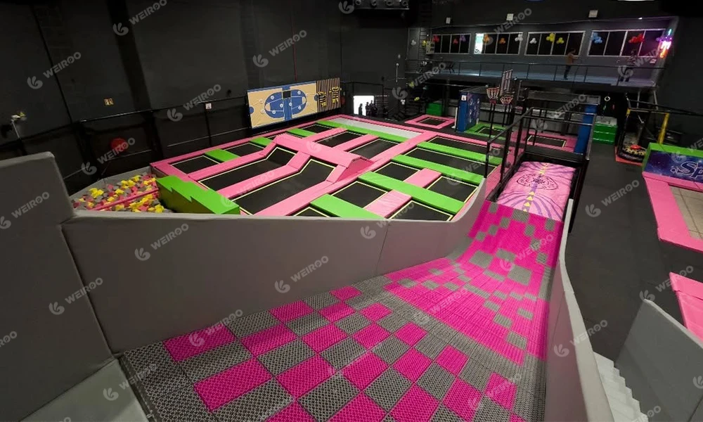 Indoor dry ski donut slide with airbag landing for trampoline parks.