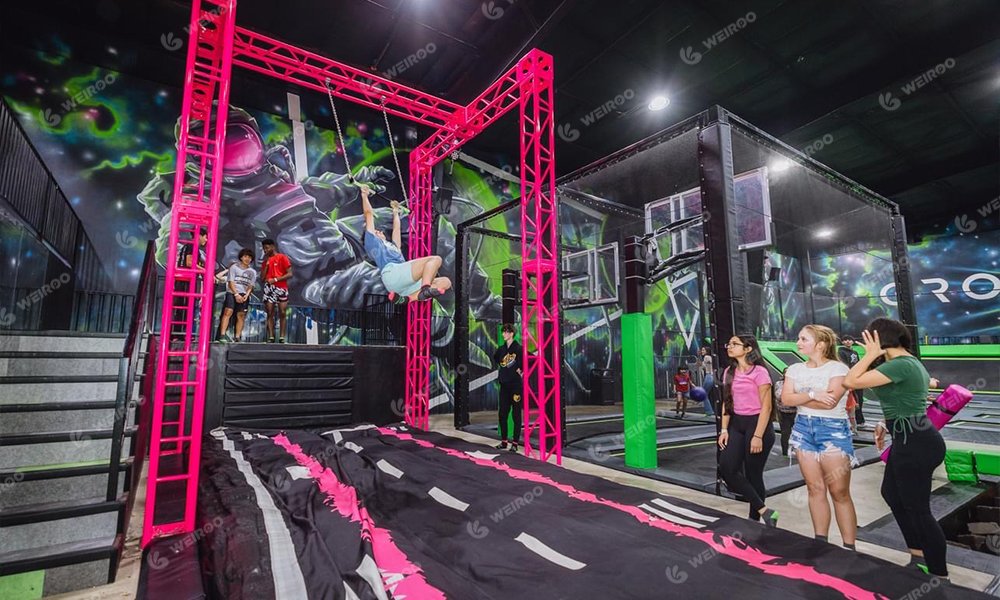 High-intensity trapeze swing attraction launching into foam pit or airbag.