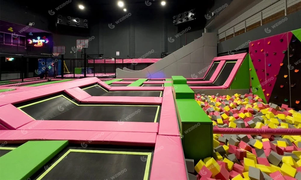 Indoor climbing wall section combined with foam pit for safety.