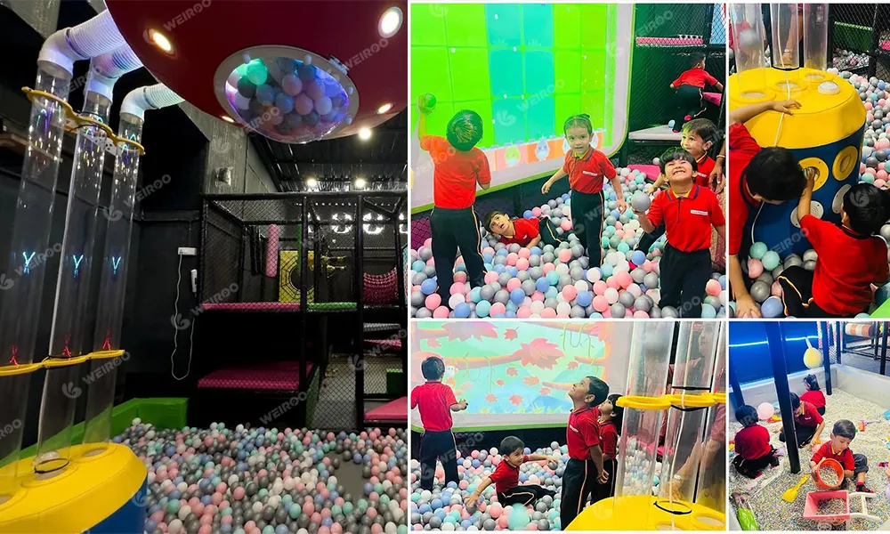 Interactive ball fountain machine inside the soft play ball pit zone for toddlers.