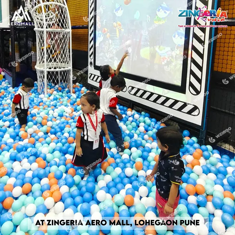 Interactive projection wall game where kids throw balls at digital targets.