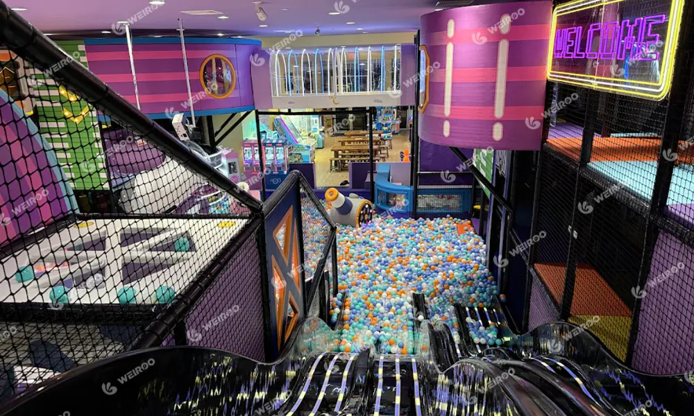 Vibrant LED streaming slide serving as the main attraction in the renovated playground.