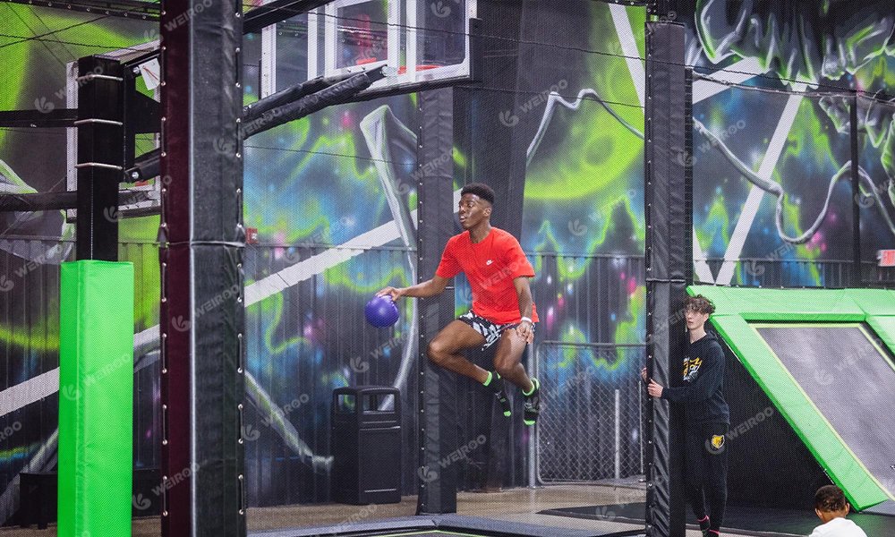 Trampoline basketball zone with higher hoops customized for adult players.