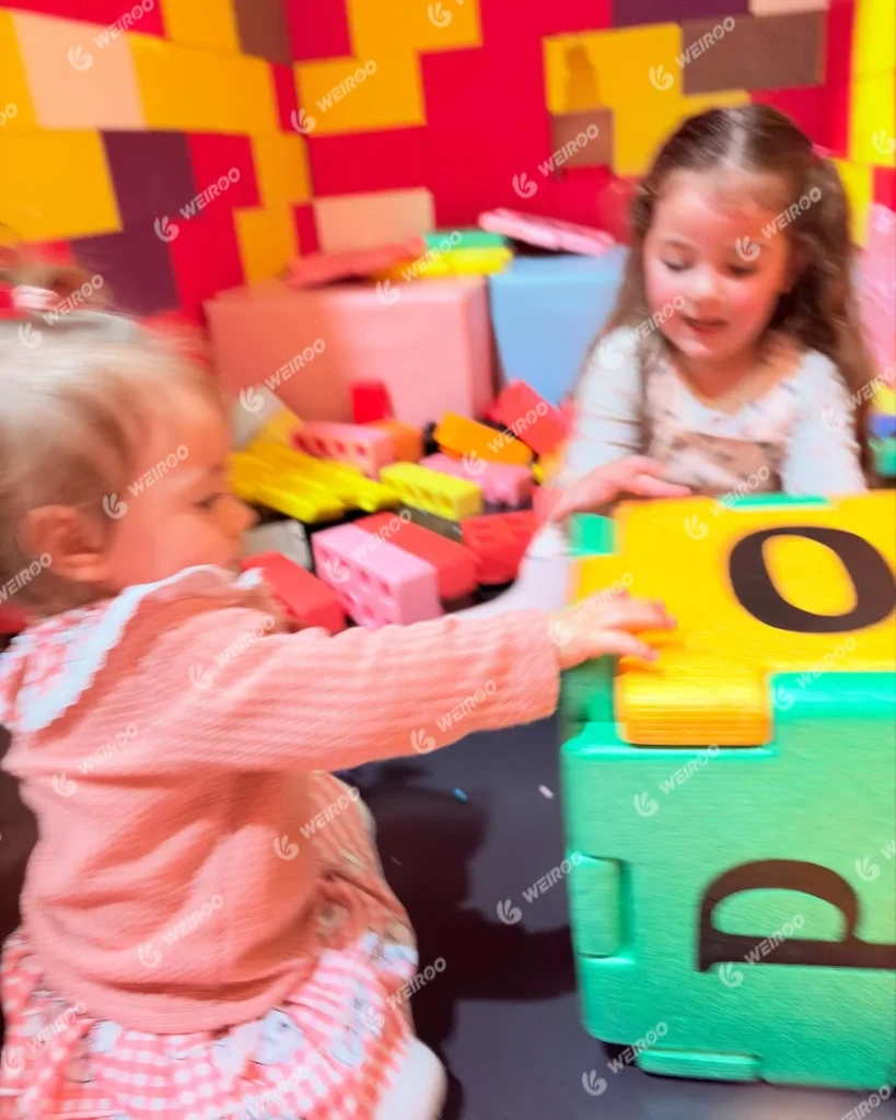 Children building towers with lightweight EPP foam blocks.