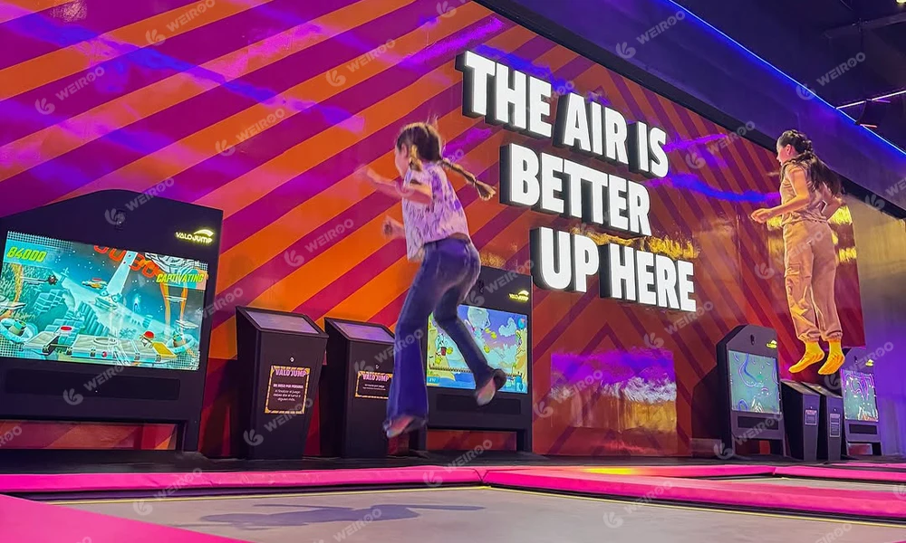 Player using AR interactive trampoline screen to play video games by jumping.