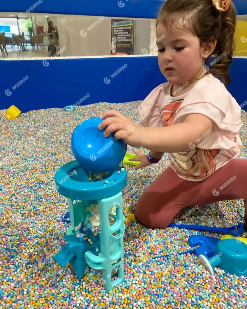Hygienic imitation ceramic sand pit with sensory funnels for toddlers.