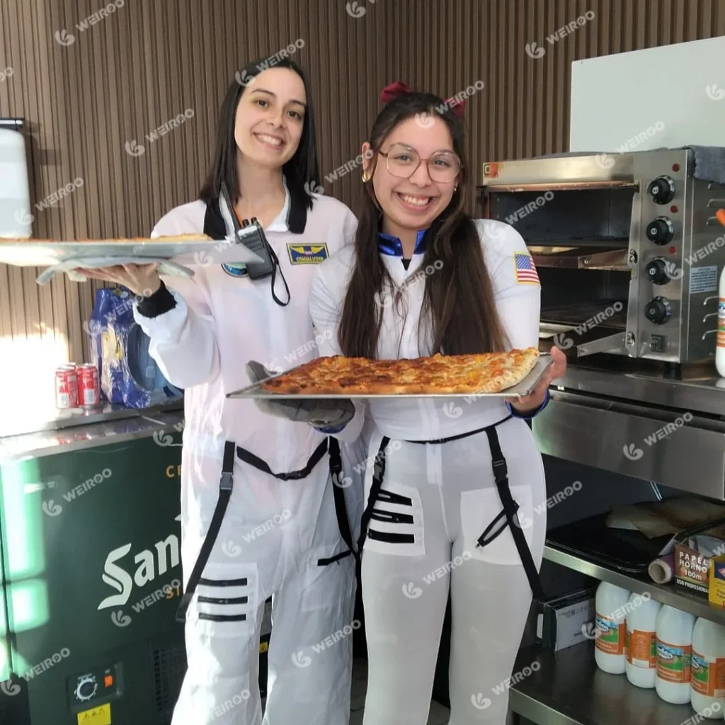 Staff serving fresh pizza at the park cafe, highlighting F&B revenue.