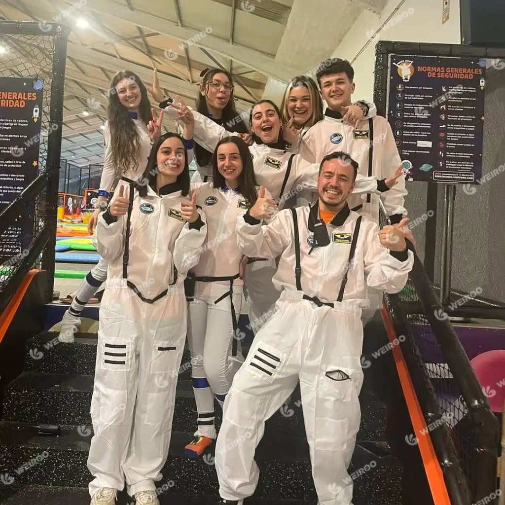 Park staff team wearing custom astronaut flight suits for space theme branding.