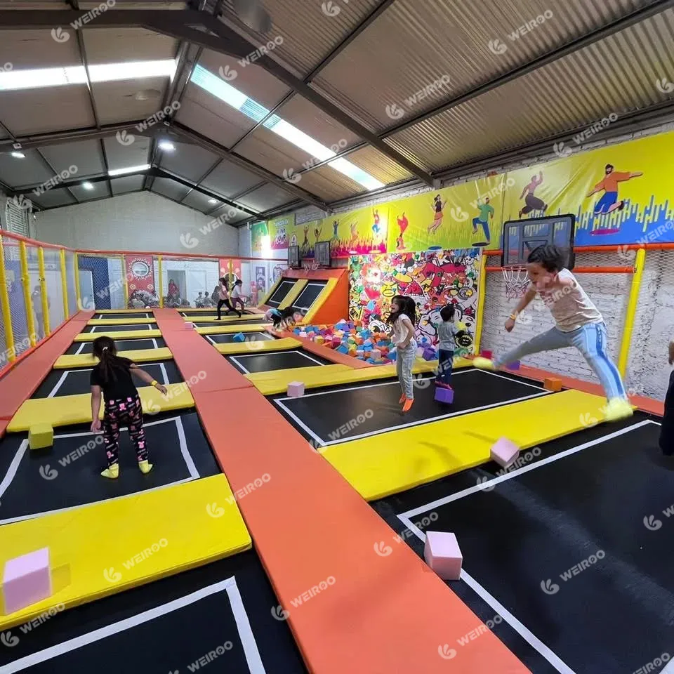 Overview of Happy Jump trampoline park in Chile inside a converted warehouse with high ceilings.