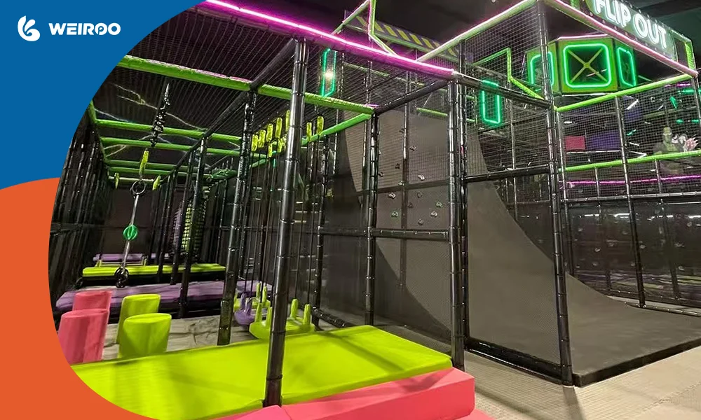 Indoor ninja warrior course featuring a warped wall and foam pit, requiring high ceiling clearance and professional scaffolding for installation.