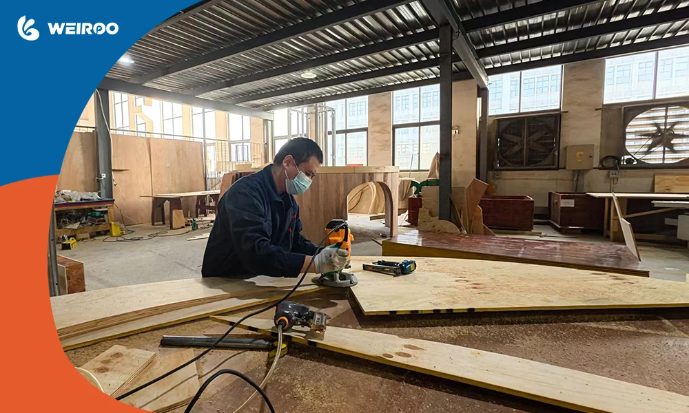 A skilled worker crafting custom components in the playground equipment supplier's factory during the 25-45 day production phase.
