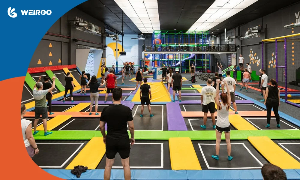 A large group of adults and teenagers using the main trampoline court for an event, maximizing the park's revenue and audience.