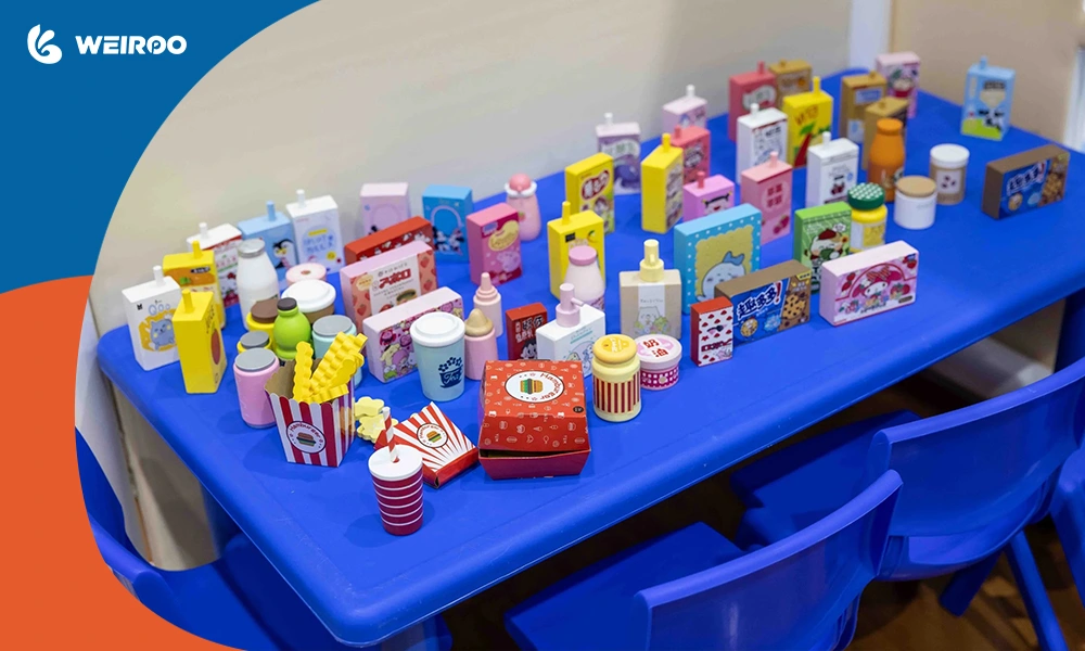 Detailed miniature supermarket and pretend food toys inside an immersive role-play village, a must-have for modern indoor play areas.