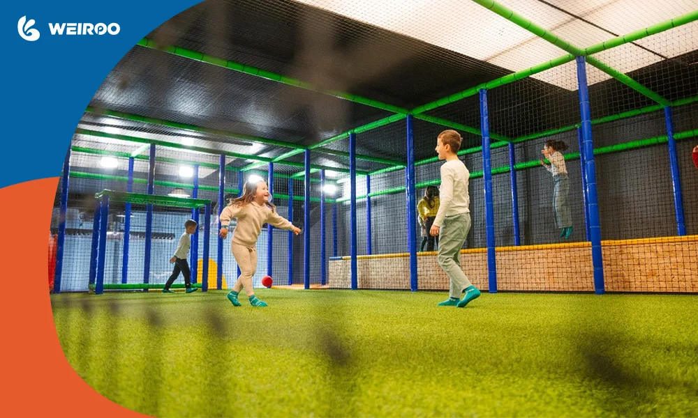 An indoor turf soccer arena integrated into a trampoline park setup to keep older kids entertained for hours.