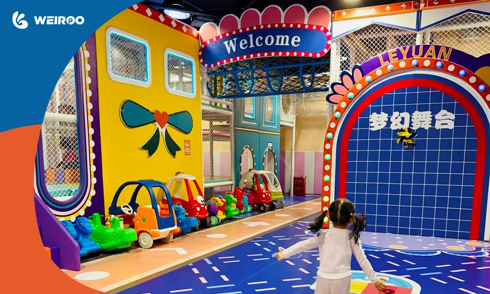 An open toddler play area with ride-on cars and custom road-themed PVC flooring, illustrating smart space allocation designed by expert playground equipment manufacturers.·