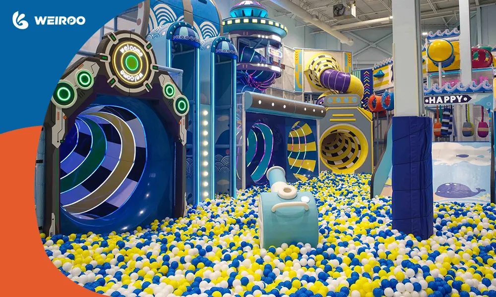 An interactive pneumatic ball blaster cannon aiming into a massive ball pit with smooth ocean balls.