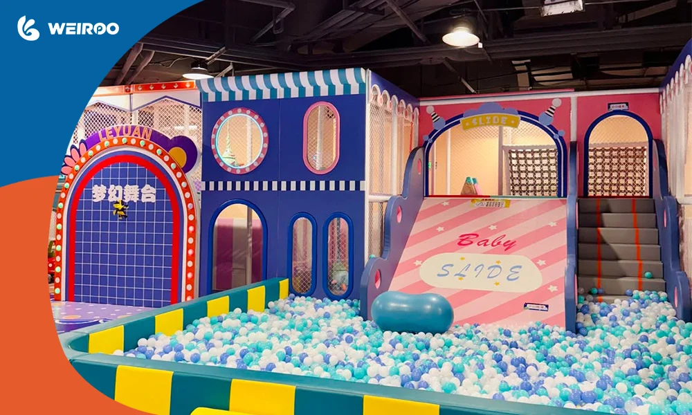 A dedicated toddler soft play zone featuring a small slide and thick safety padding, a crucial layout element when figuring out what do you need to open an indoor playground.