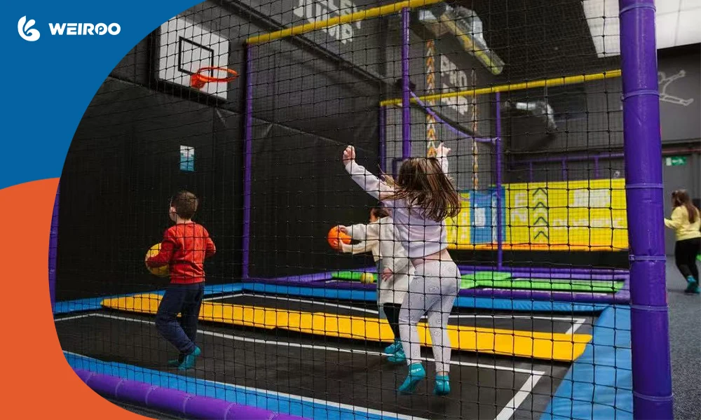 An enclosed trampoline dodgeball and basketball arena, a mandatory attraction when you buy trampoline park equipment.