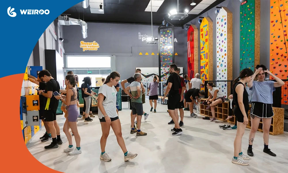 Customers preparing in the locker and climbing wall area. Selling custom grip socks here is a highly profitable part of the business.