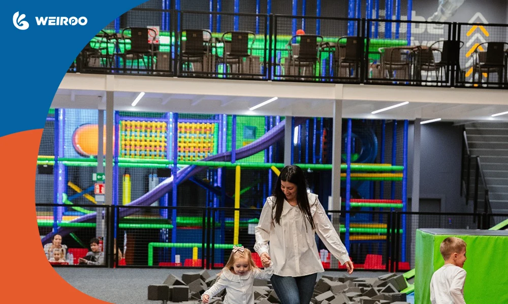 A multi-level trampoline park layout featuring a play zone below and a watchtower parent cafe above for clear safety monitoring.