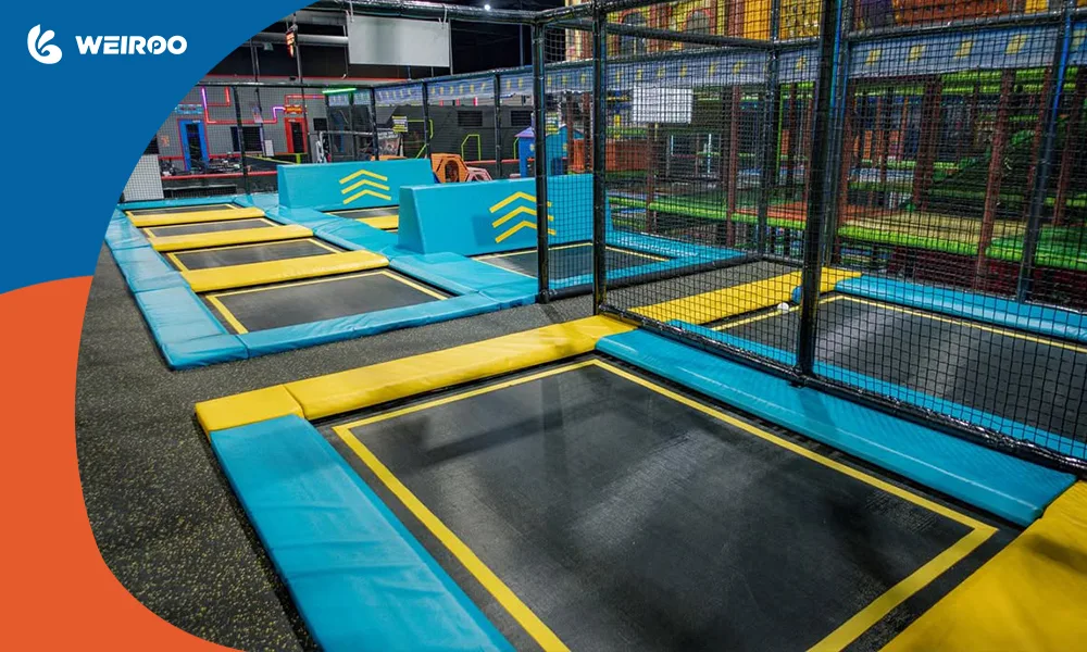 Close-up of high-quality, interconnected trampoline mats with thick safety padding, demonstrating standard park equipment.