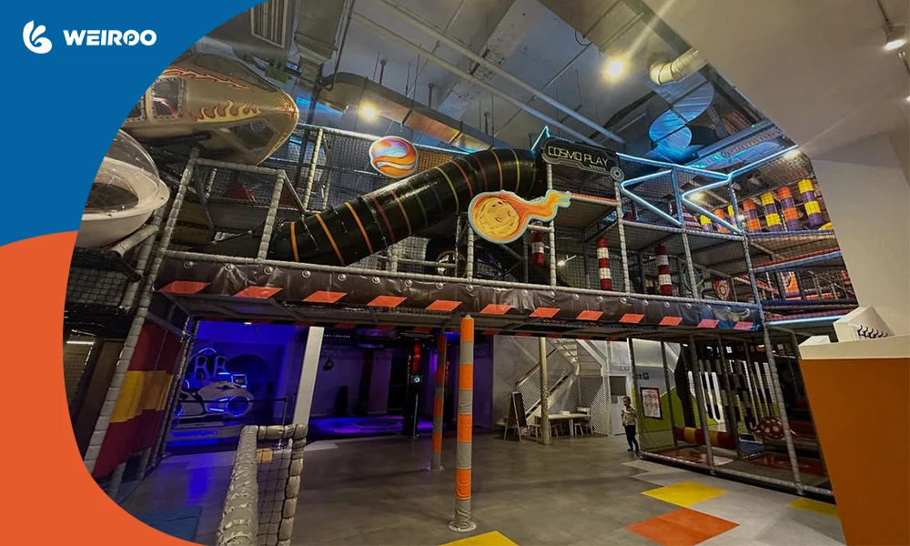 A comprehensive view of a large, space-themed multi-level indoor playground structure, demonstrating complex commercial play system designs.